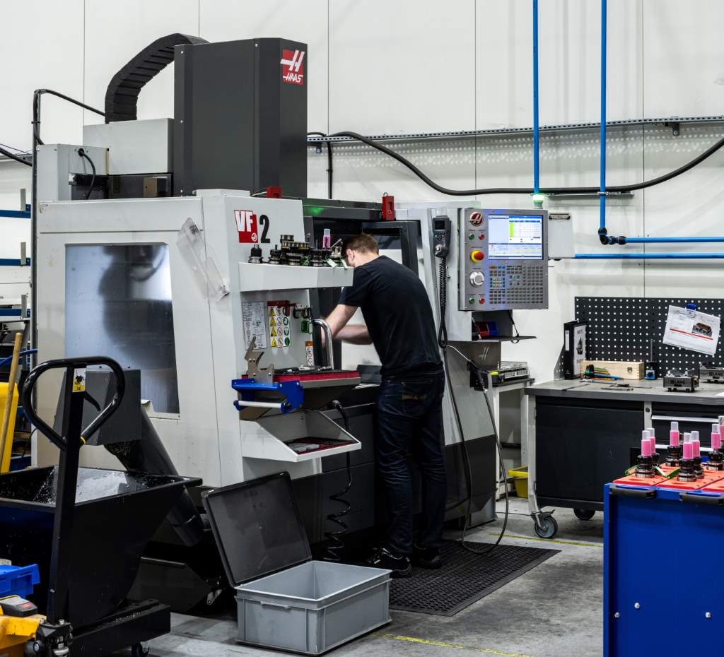 Machinist setting up a Haas VF-2 vertical mill